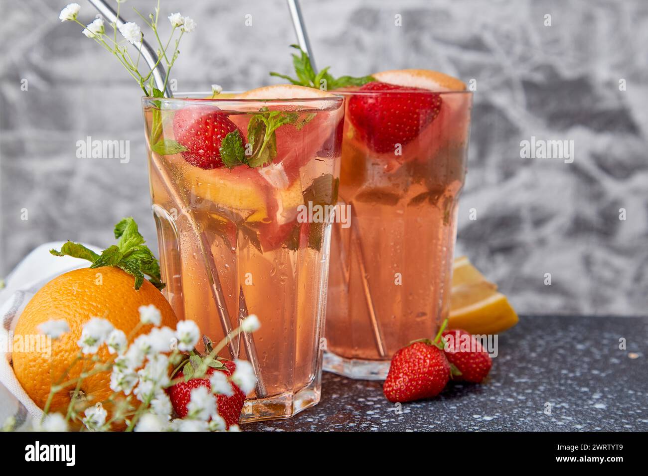 Refreshing aesthetic cocktails with citrus fruits and strawberry. Vitaminized summer detox water. Low alcohol, zero proof beverages Stock Photo