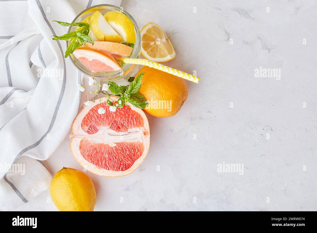 Summer mocktail with citrus fruits. Vitaminized detox water. Low alcohol, zero proof drinks. Top view, copy space Stock Photo