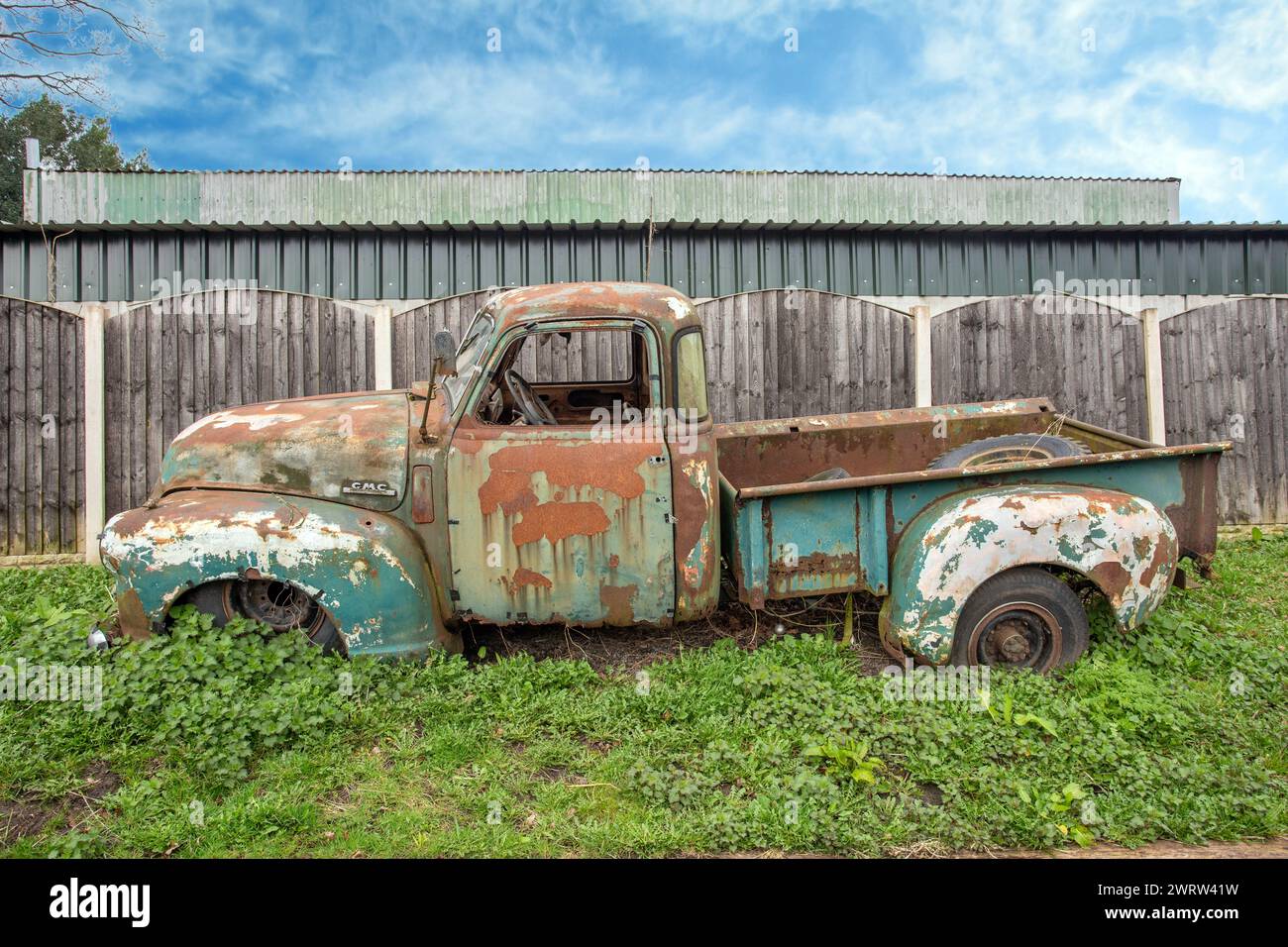 Old abandoned  1940s  General Motors Company GMC pick up truck at a breakers in the Cheshire village of Smallwood Stock Photo