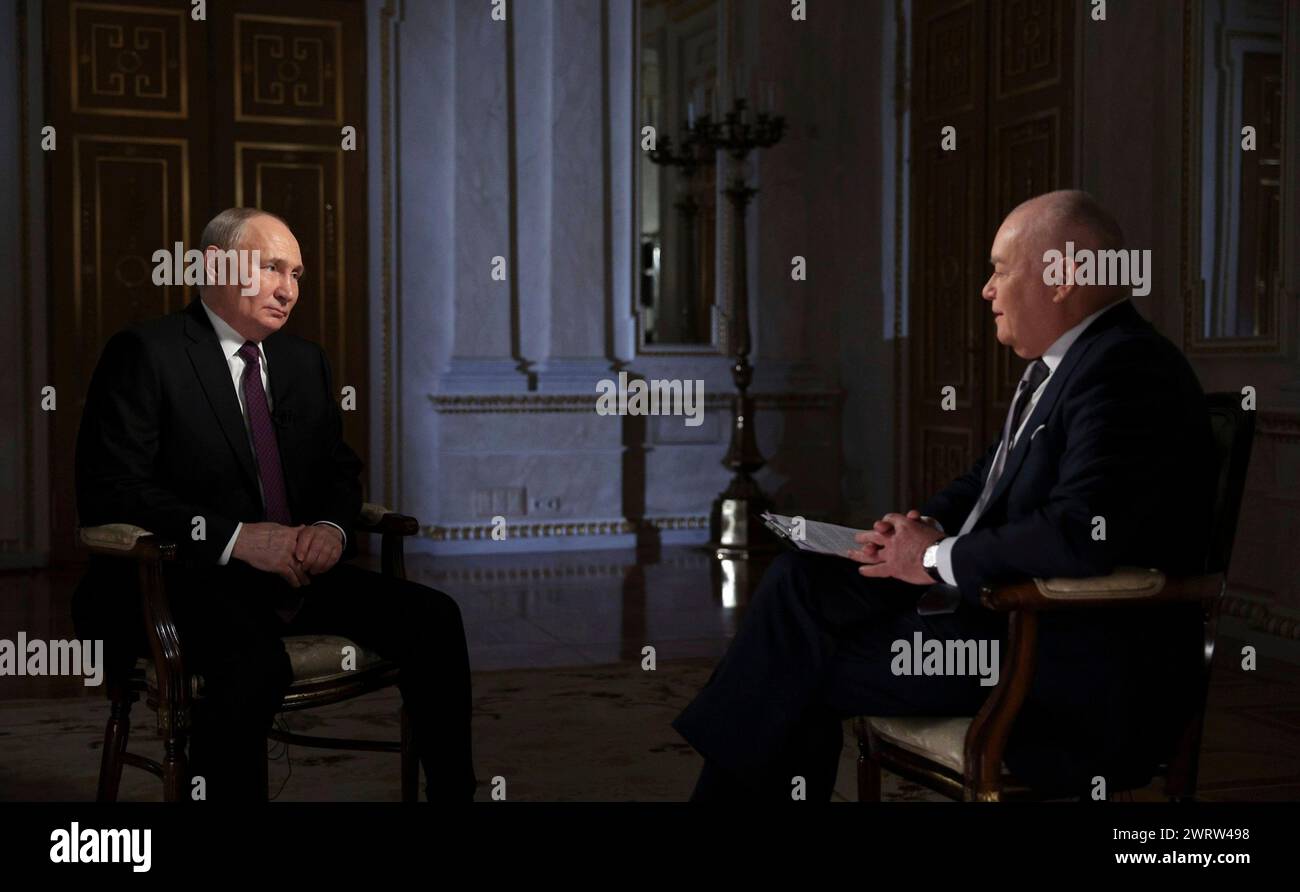 Moscow, Russia. 12th Mar, 2024. Russian President Vladimir Putin listens to a question during an interview with Rossiya Segodnya International Media Group Director General Dmitry Kiselev, right, at the Kremlin, March 12, 2024 in Moscow, Russia. Credit: Mikhail Metzel/Kremlin Pool/Alamy Live News Stock Photo