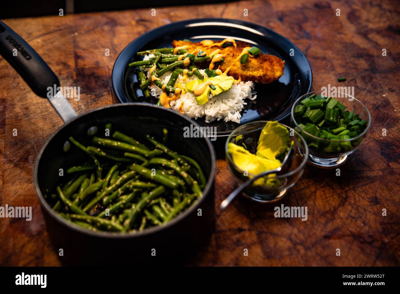 A plate of assorted meats, rice, and green beans Stock Photo