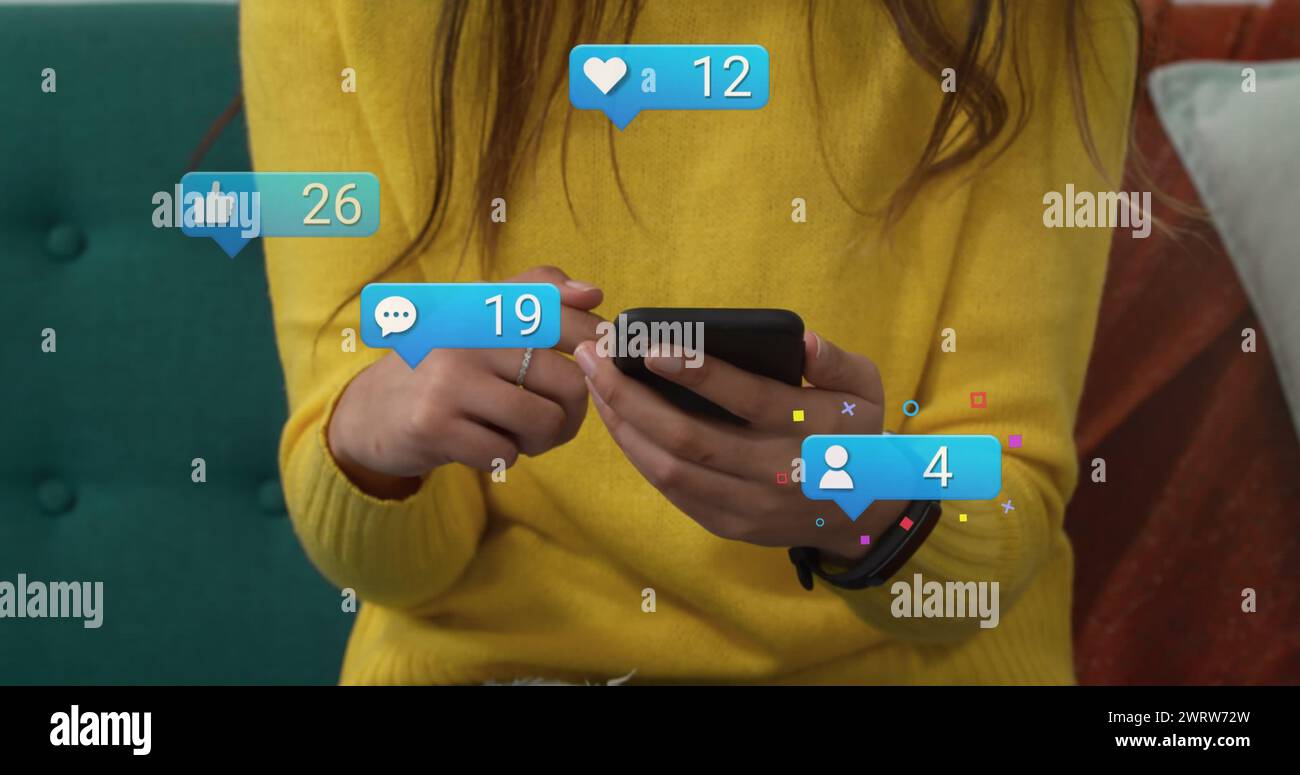 Image of social media reactions over hands of caucasian woman using smartphone Stock Photo