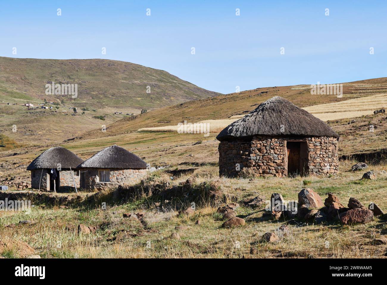 Semonkong, Lesotho - April 22nd 2023 - group of traditional round huts made of stones near Semonkong Stock Photo