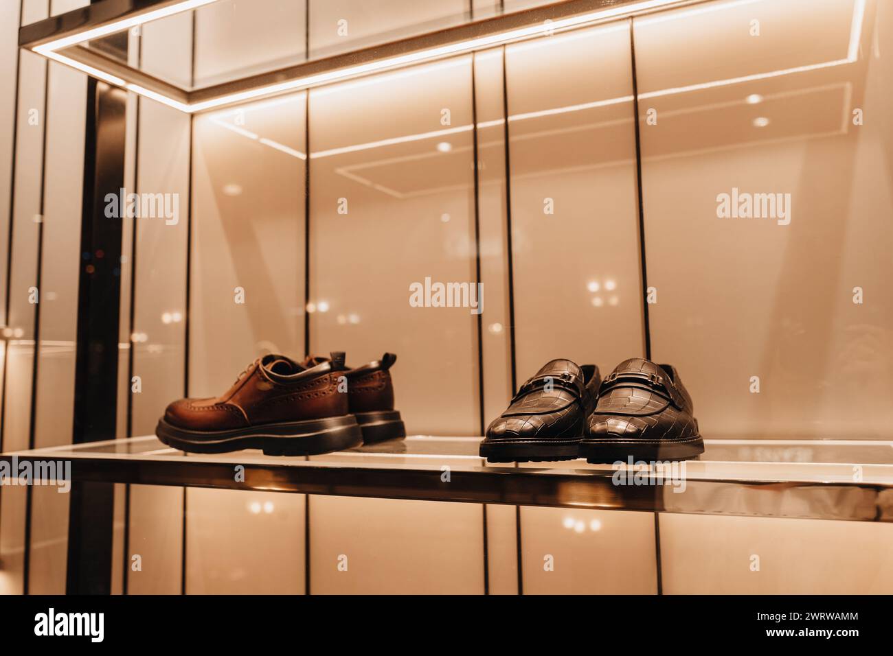 Men's stylish leather shoes on display in a luxury boutique Stock Photo
