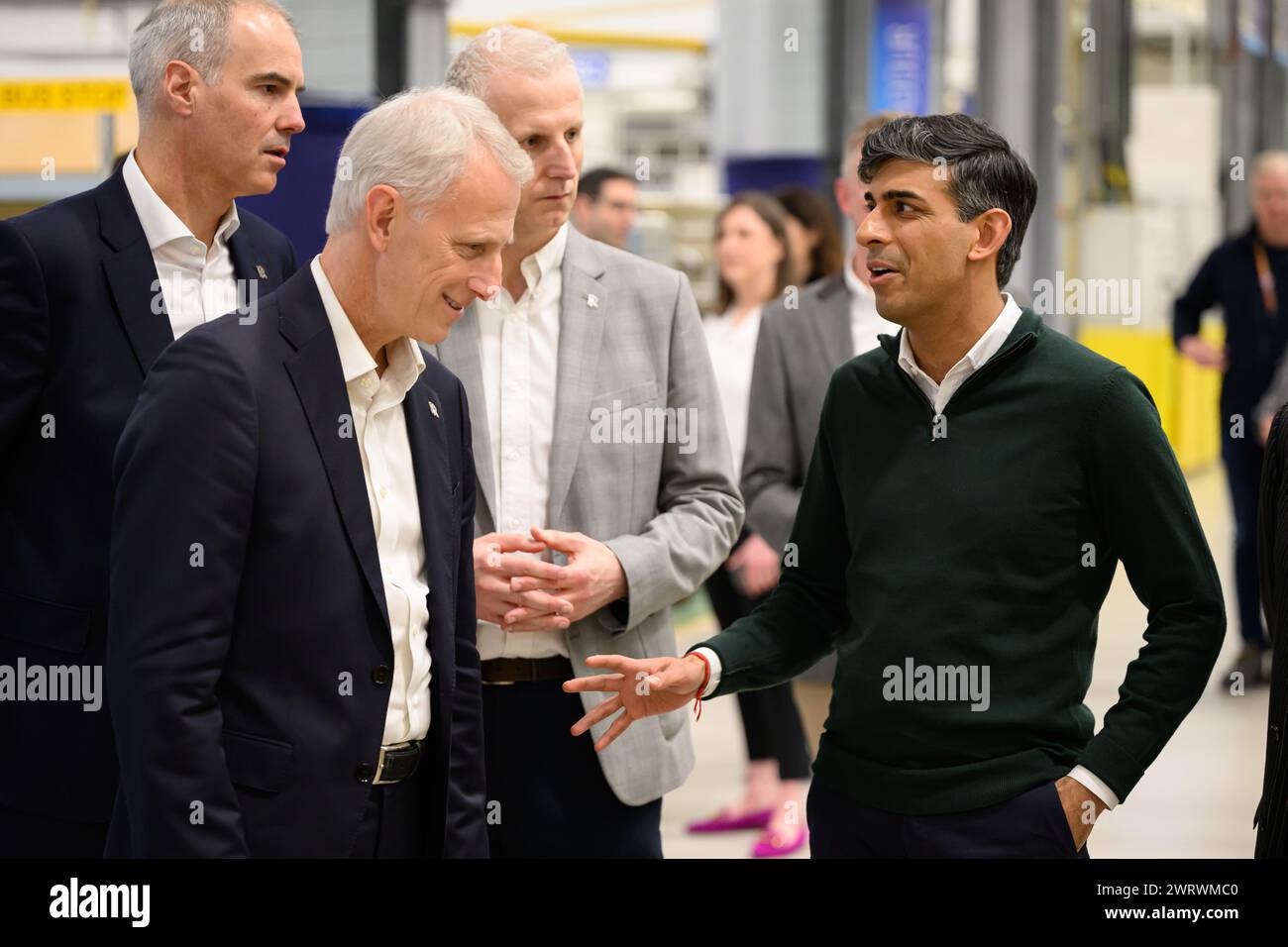 Prime Minister Rishi Sunak (right) speaks with Rolls-Royce Group President Chris Cholerton (second left) and Director of Business Development & Future Programmes, Rolls-Royce plc, Alex Zino (left), during a visit to the Rolls-Royce manufacturing facility in Bristol. Picture date: Thursday March 14, 2024. Stock Photo