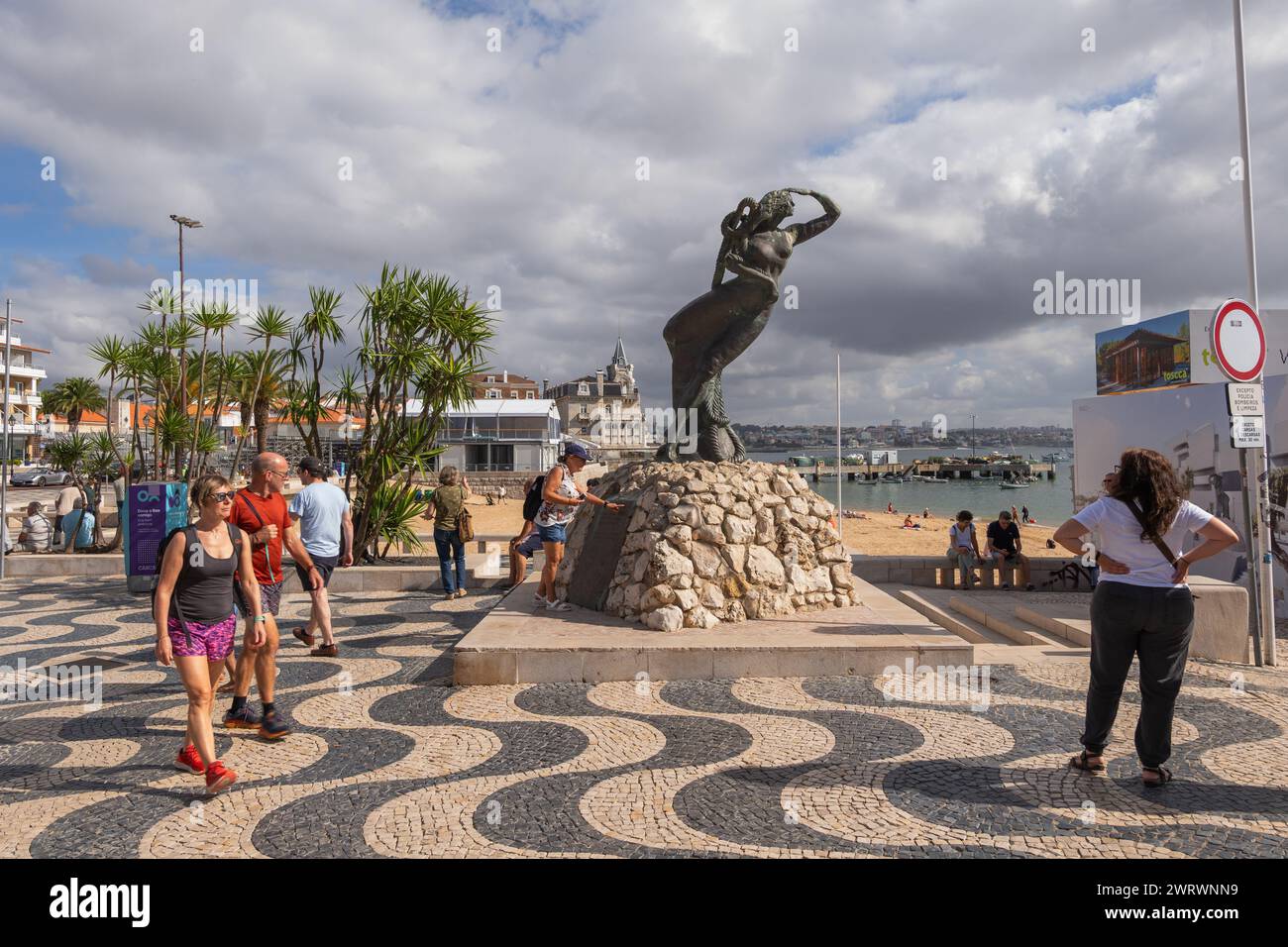 Cascais, Portugal - October 14, 2023: Tourists on seaside square with Monument for the Portuguese Discoveries in resort town in Lisbon District. Stock Photo