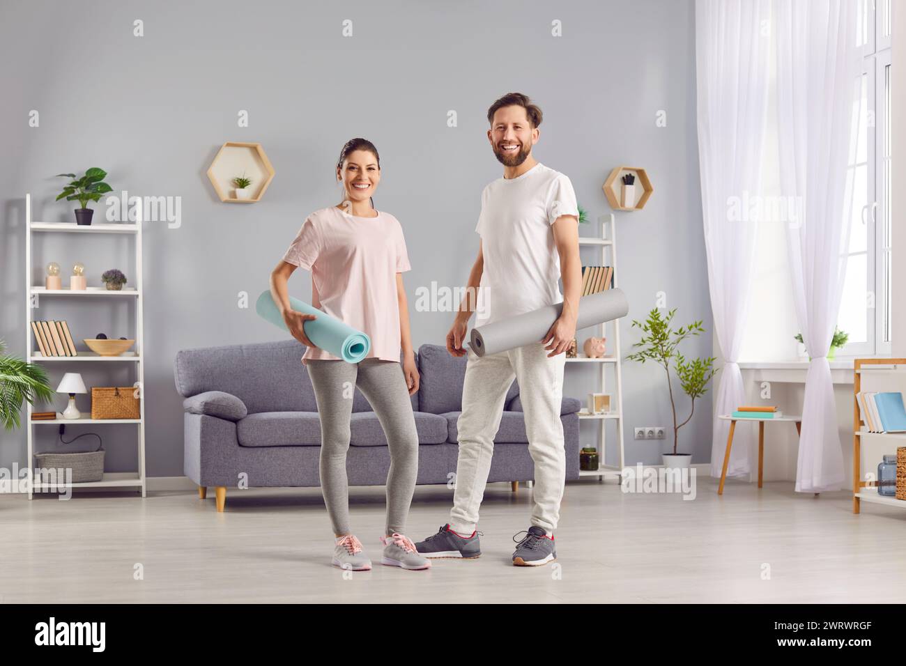 Smiling Athlete Couple Taking A Break At Home Stock Photo