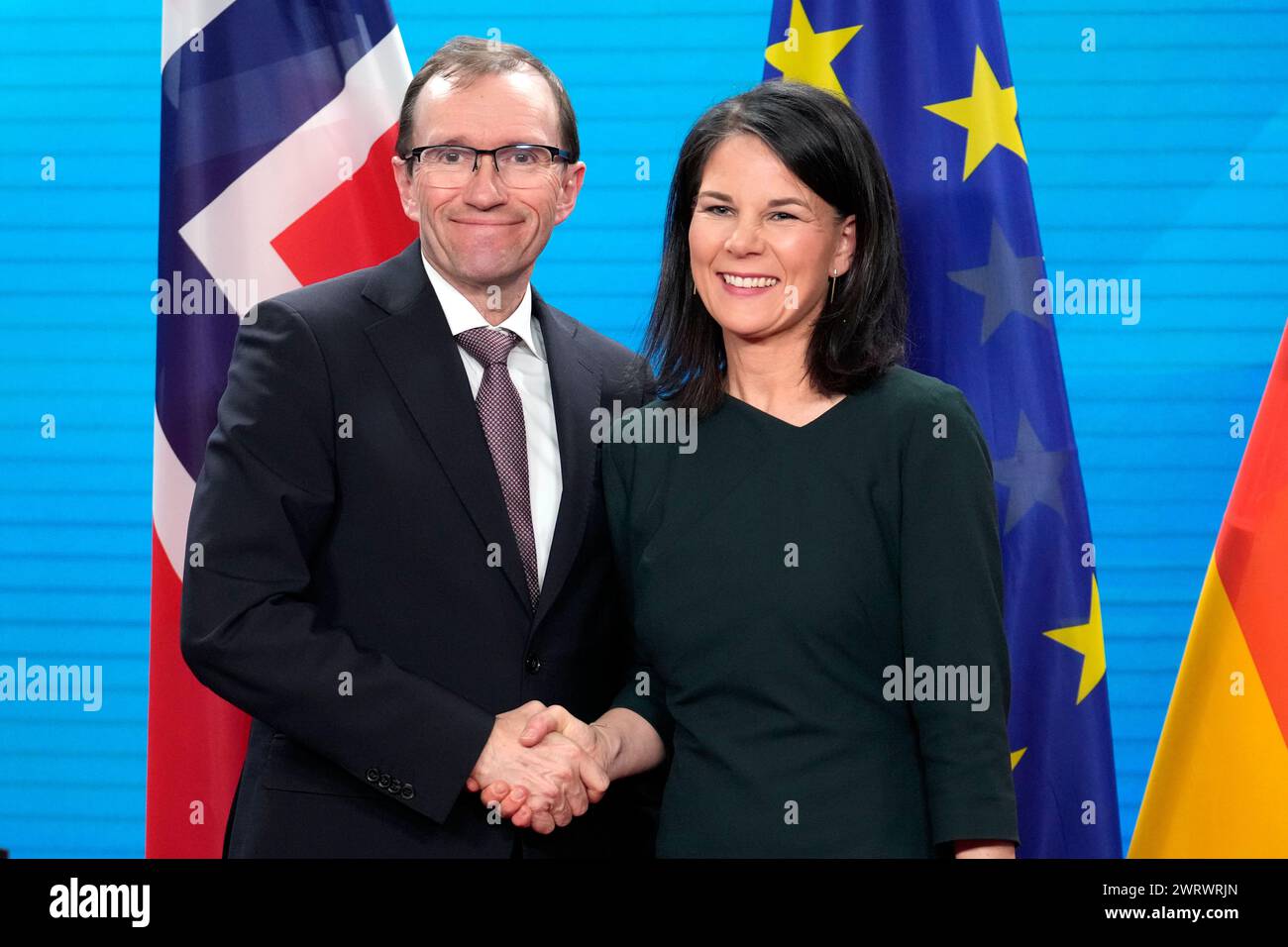 German Foreign Minister Annalena Baerbock, right, shakes hands with her
