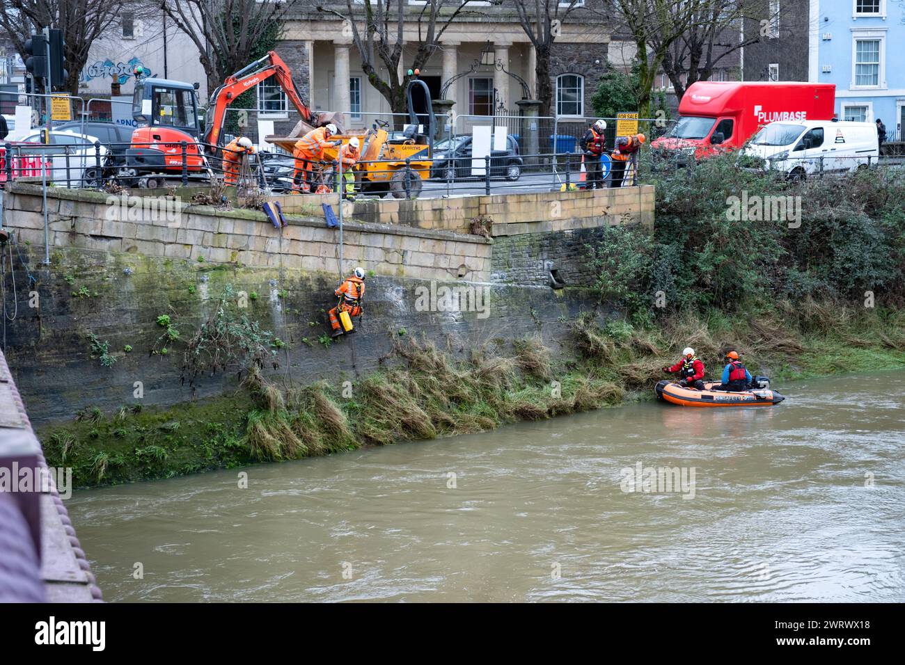 Bristol, UK. Workman carrying out repairs to a river wall on the River Avon New Cut as part of the city councils river walls stabilisation project Stock Photo