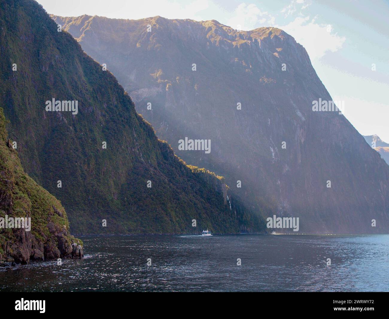 Sunshine above the fjord, Milford Sound - New Zealand Stock Photo