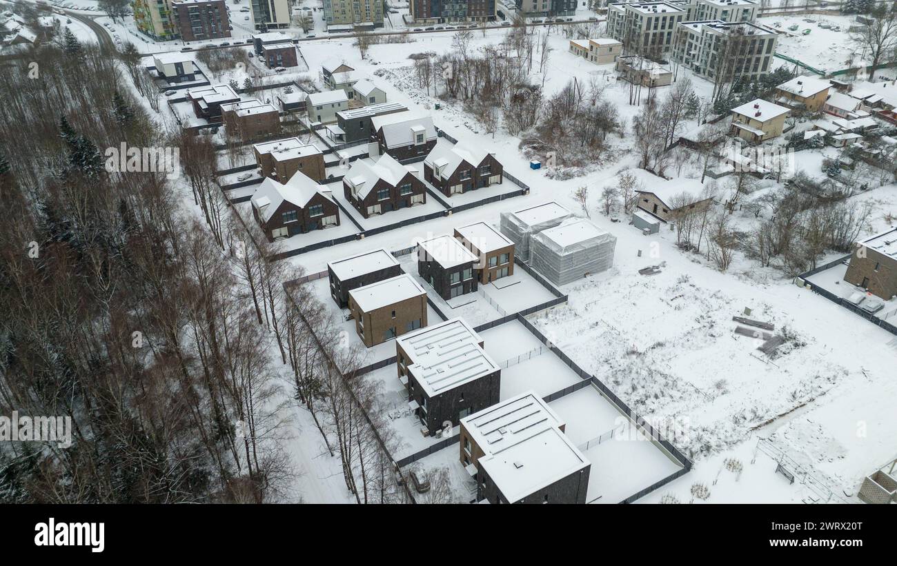 Drone photography of a city landscape, buildings, public parks covered in snow during winter cloudy day Stock Photo