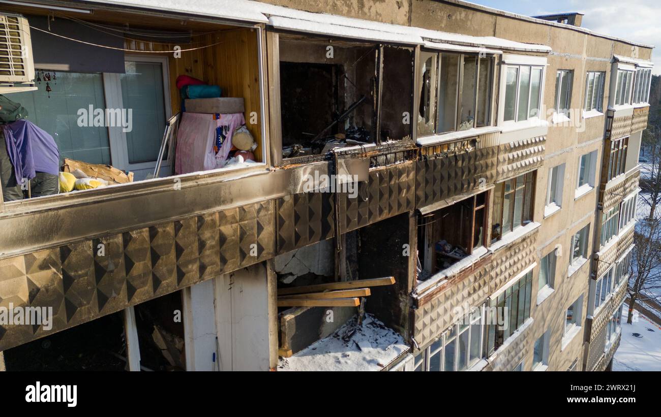 Drone photography of a few burned up apartments in in multistory houses and iced up windows during sunny winter day Stock Photo