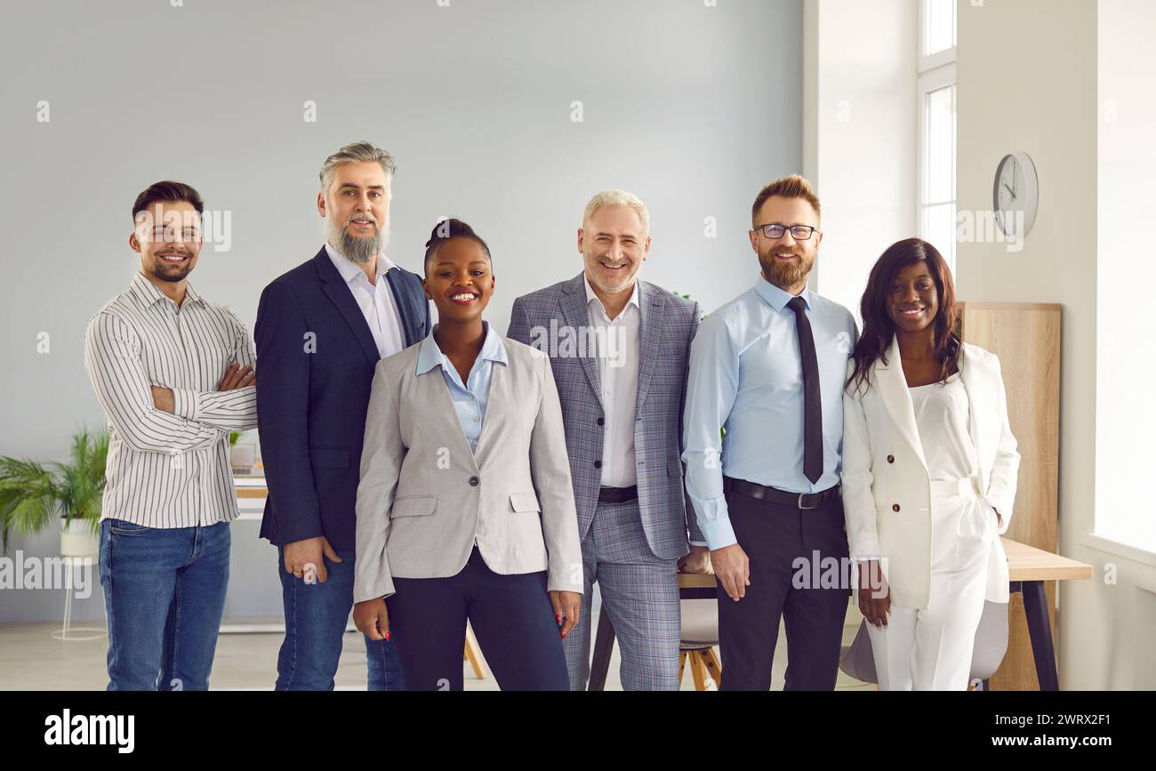 Group of smiling business people posing together in office Stock Photo ...