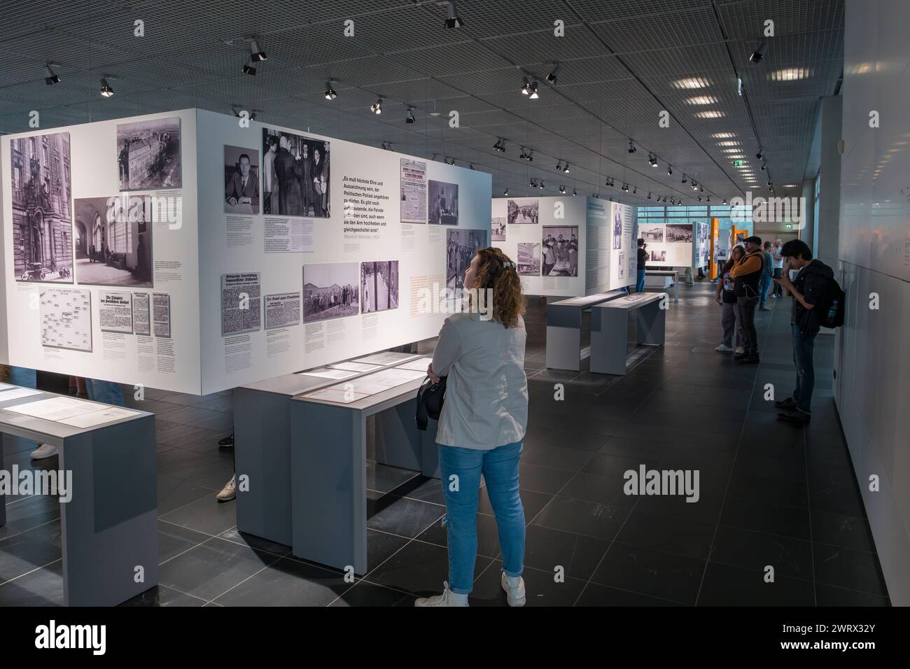 General view of visitors looking at the horrific images of the Nazi regime and the Holocaust in the Topography of Terror, Berlin, Germany. Stock Photo