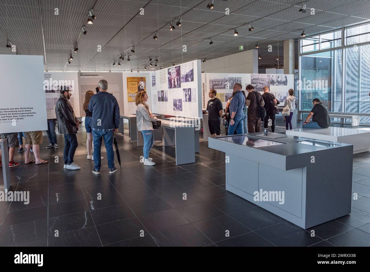General view of visitors looking at the horrific images of the Nazi regime and the Holocaust in the Topography of Terror, Berlin, Germany. Stock Photo