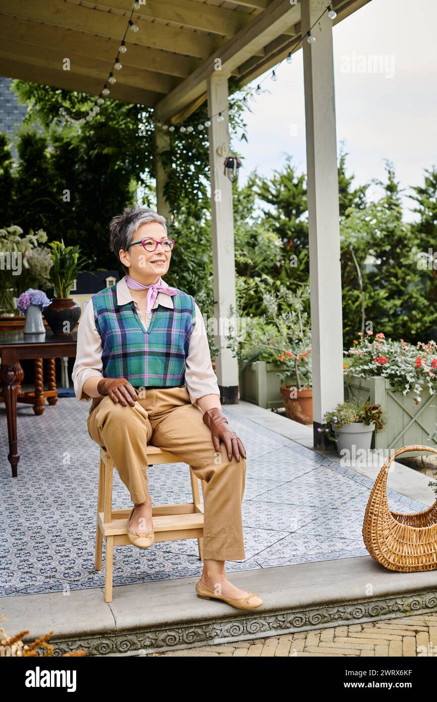 Mature woman sitting on chair hi-res stock photography and images - Alamy