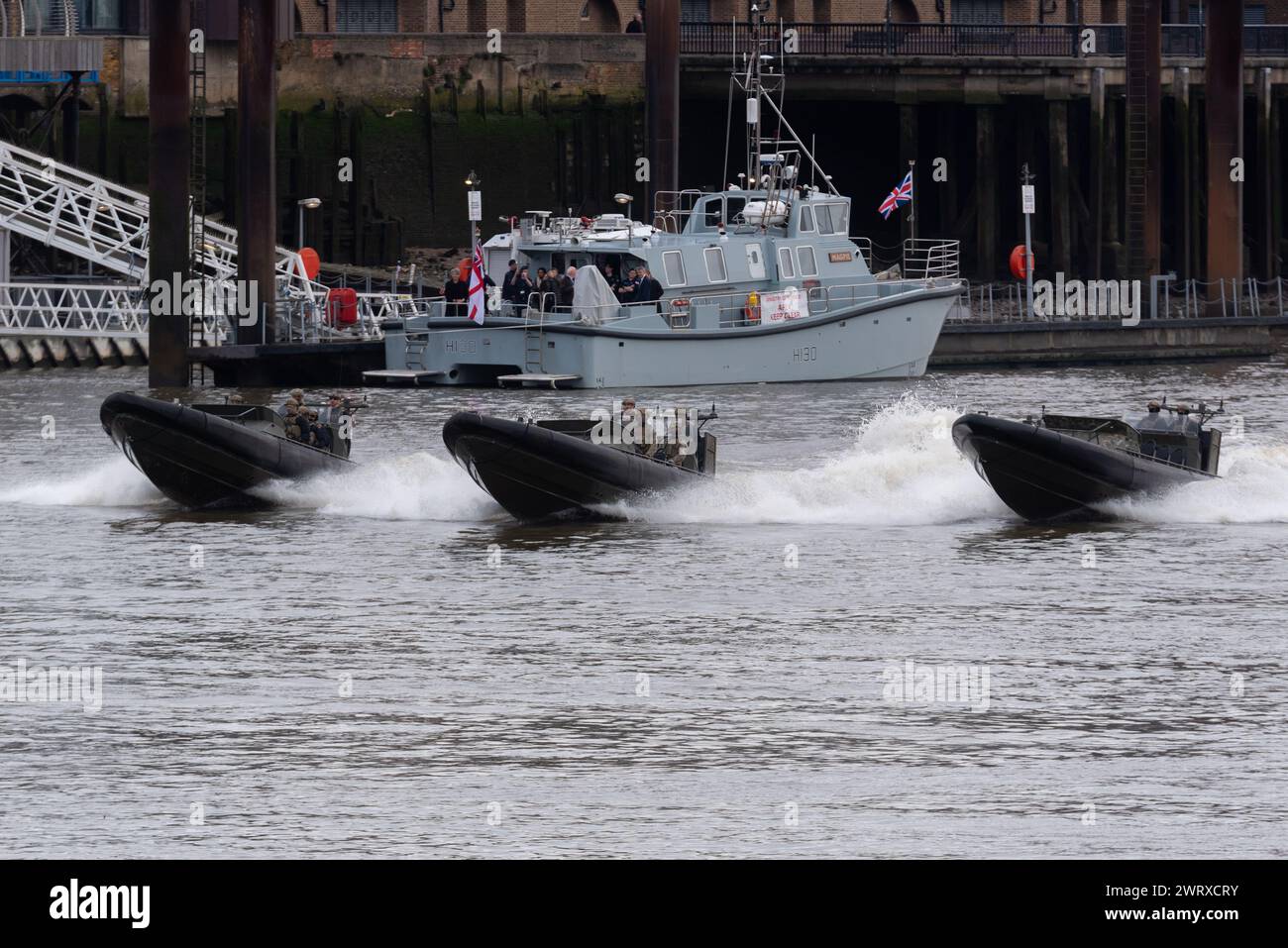 Royal Marines Commandos taking part in Constable's Dues traditional event by the Tower of London, UK. Riding in Offshore Raiding Craft on River Thames Stock Photo