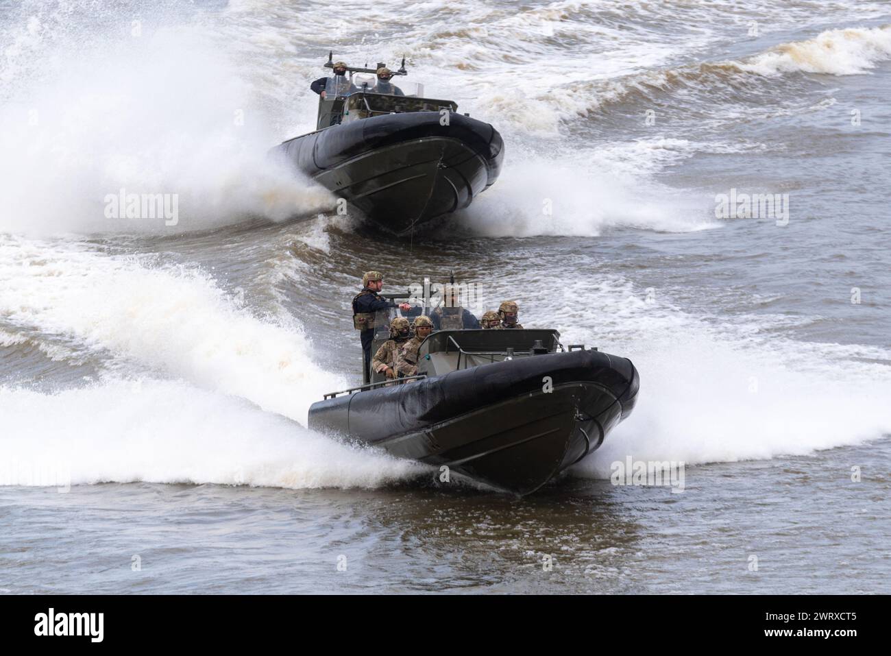 Royal Marines Commandos taking part in Constable's Dues traditional event by the Tower of London, UK. Riding in Offshore Raiding Craft on River Thames Stock Photo