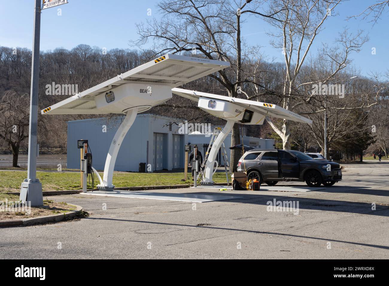 a solar electricity vehicle charging station designated exclusively for city owned vehicles, in Inwood Hill Park, new york city, by Beam EV charging, Stock Photo