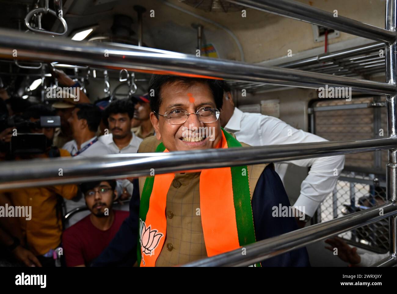 Mumbai, India. 14th Mar, 2024. MUMBAI, INDIA - MARCH 14: Piyush Goyal, Minister of Textiles, Minister of Commerce and Industry and Minister of Consumer Affairs, Food and Public Distribution shares the light moment with co-passenger while traveling between Dadar Railway Station to Borivali Railway Station in 2nd Class compartment, during evening peak hours at Dadar Station, on March 14, 2024 in Mumbai, India. (Photo by Anshuman Poyrekar/Hindustan Times/Sipa USA ) Credit: Sipa USA/Alamy Live News Stock Photo