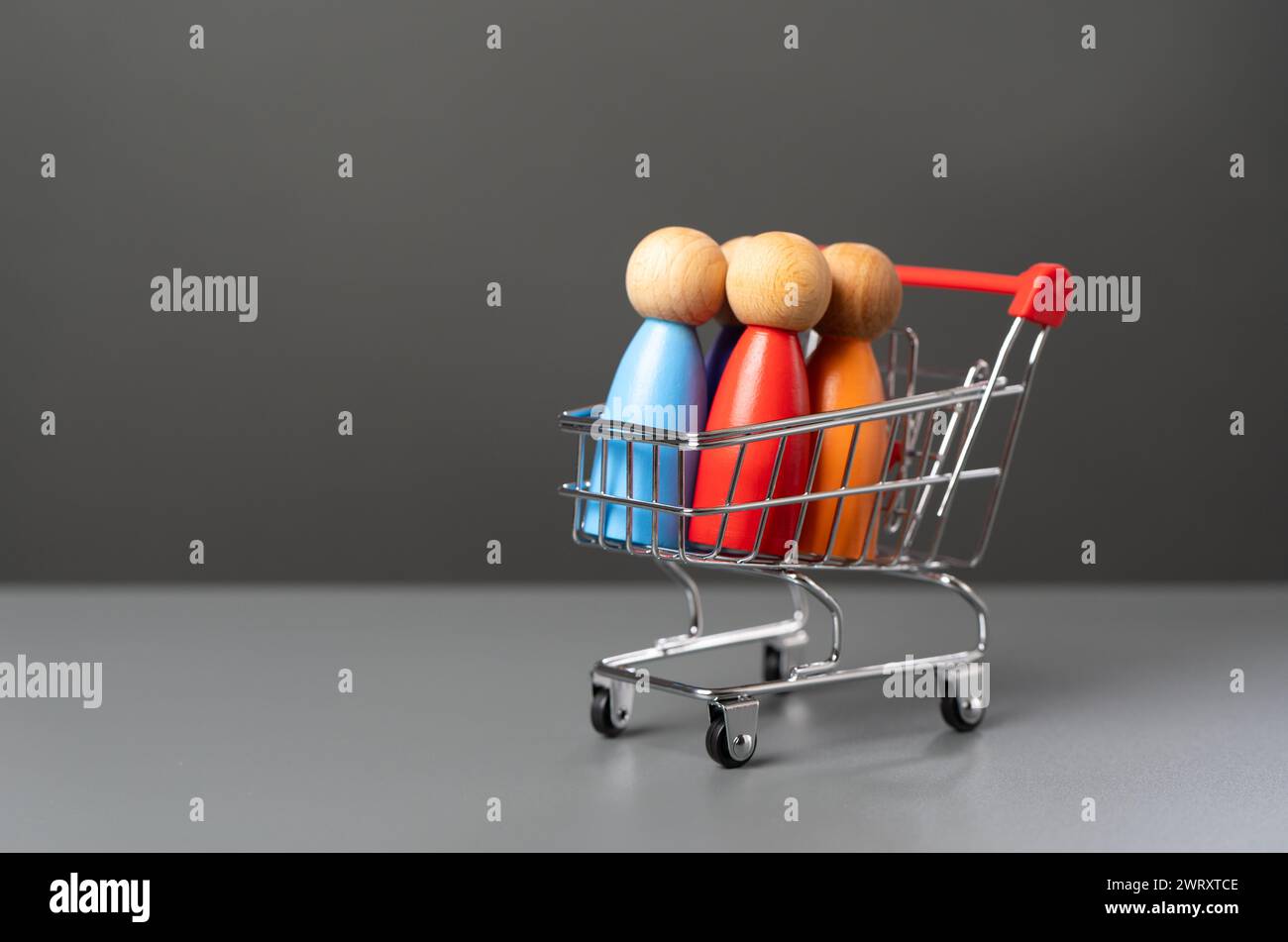 People in a shopping cart. Marketing, consumerism. Human trafficking. Products and marketing strategies. Buyer preferences. Customers Stock Photo