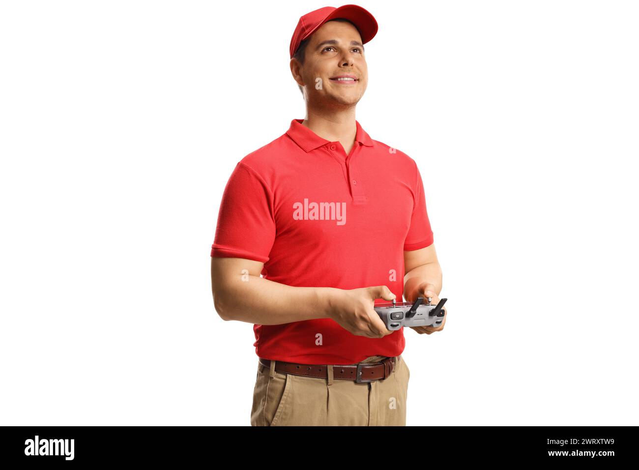 Drone operator holding a remote controller and looking up isolated on white background Stock Photo