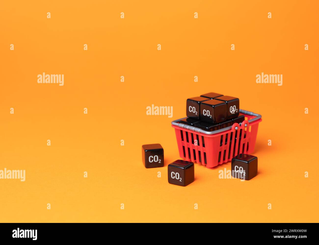 Shopping basket and cubic CO2 carbon dioxide. Greenhouse gas consumption and footprint. Customers carbon footprint. Achieve an understanding of impact Stock Photo