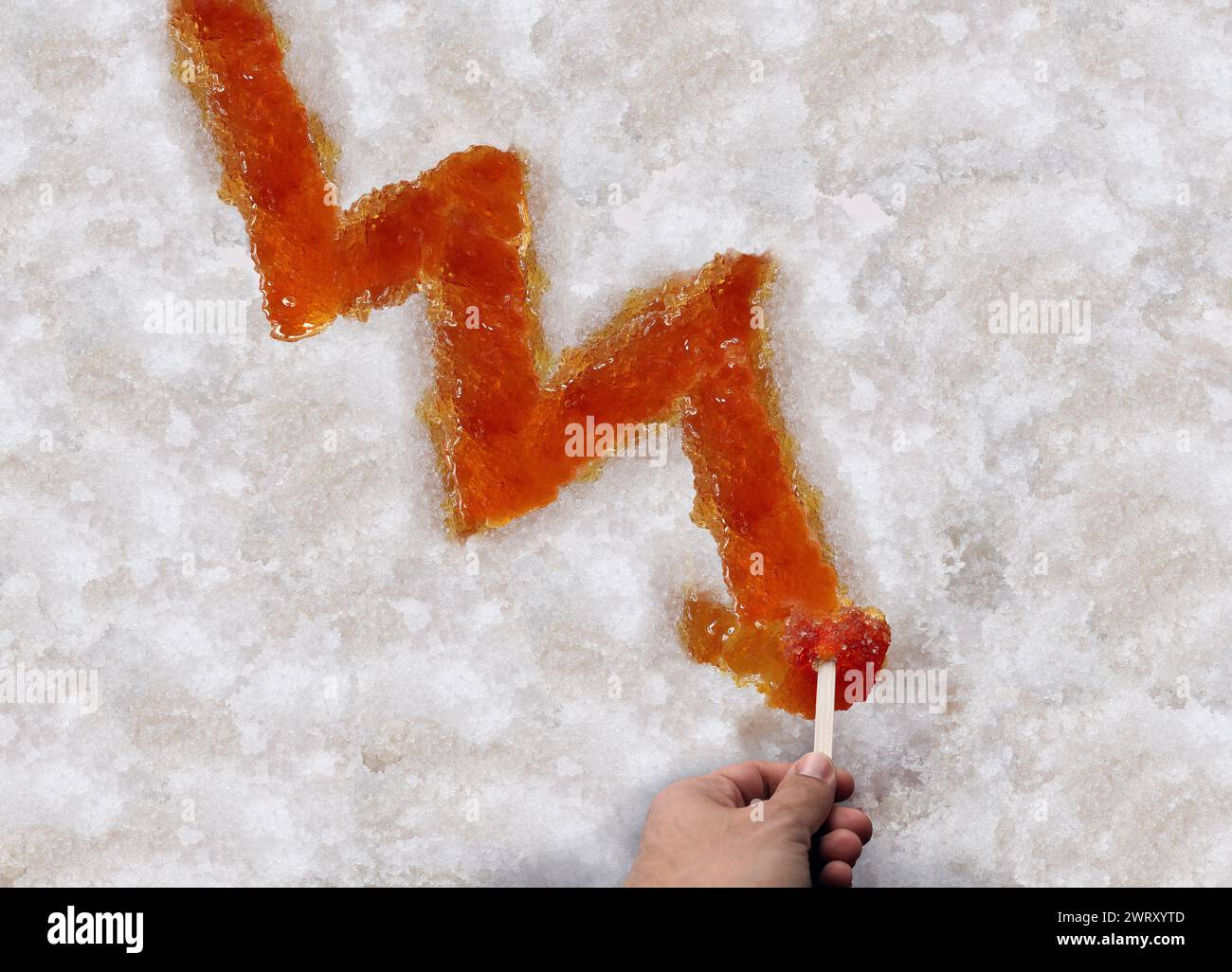 Maple syrup shortage and decline of Sugar Shack Maple taffy or sweet boiled tree sap as a downward chart arrow on snow as a traditional spring season Stock Photo