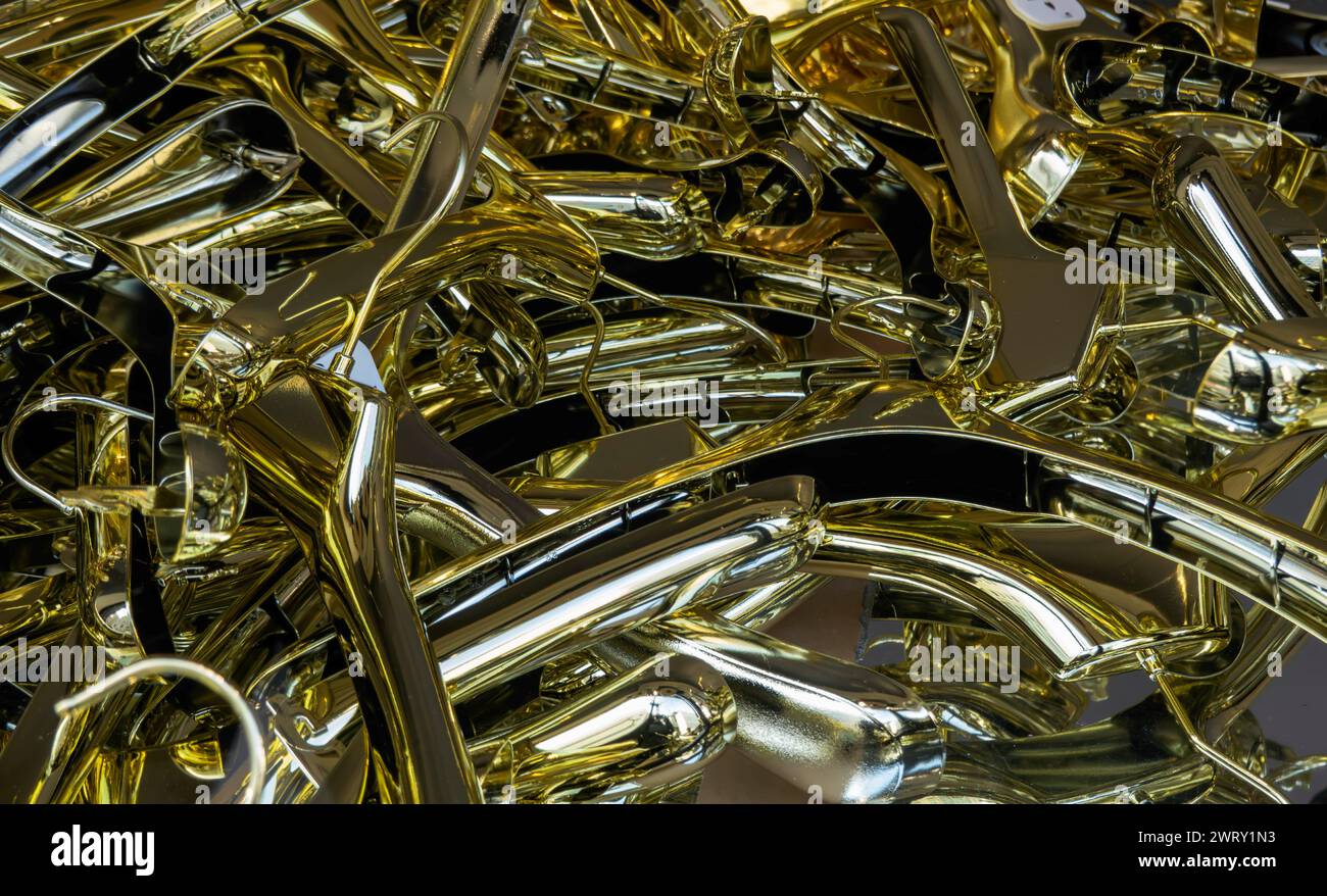 Gold coloured clothes hangers jumble Stock Photo
