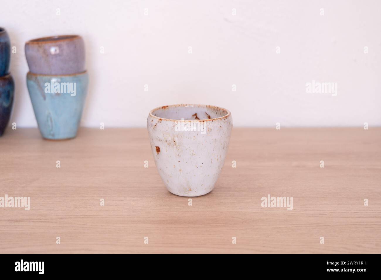 Handmade colourful cup on wooden table. High quality photo Stock Photo