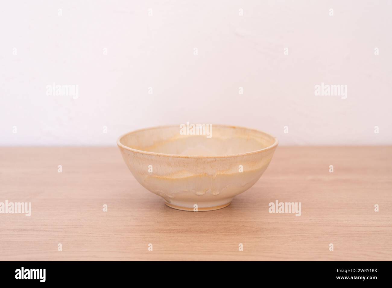 Handmade ceramic bowl, white and beige, wooden. High quality photo Stock Photo