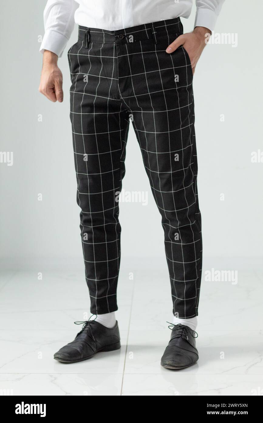 Bulgaria - 03 19 2024: Black pants for male with white stripes. Modeling. Stock Photo