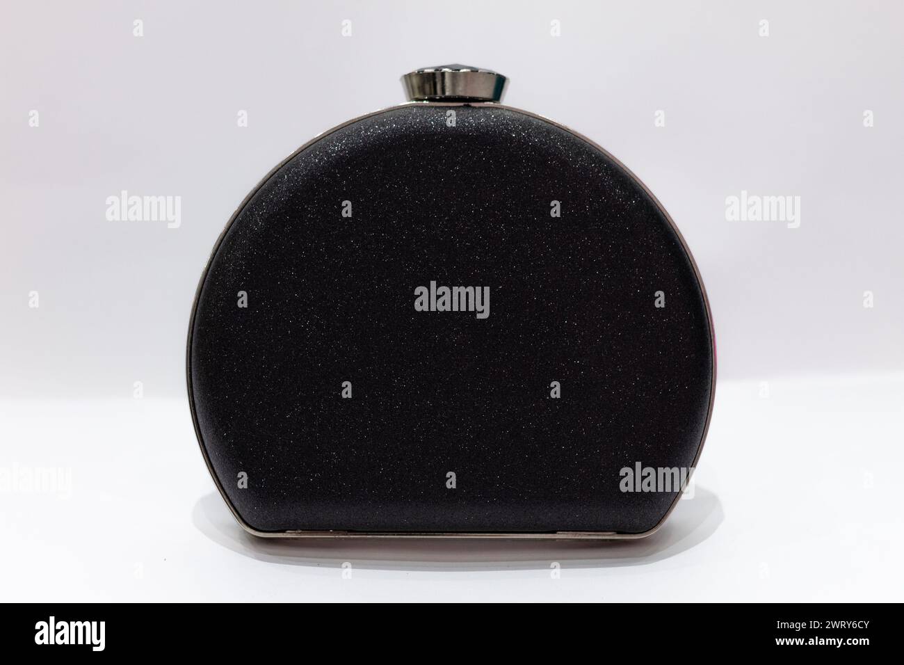 Women purse with a design in a form of a bottle. Shiny black color. Stock Photo