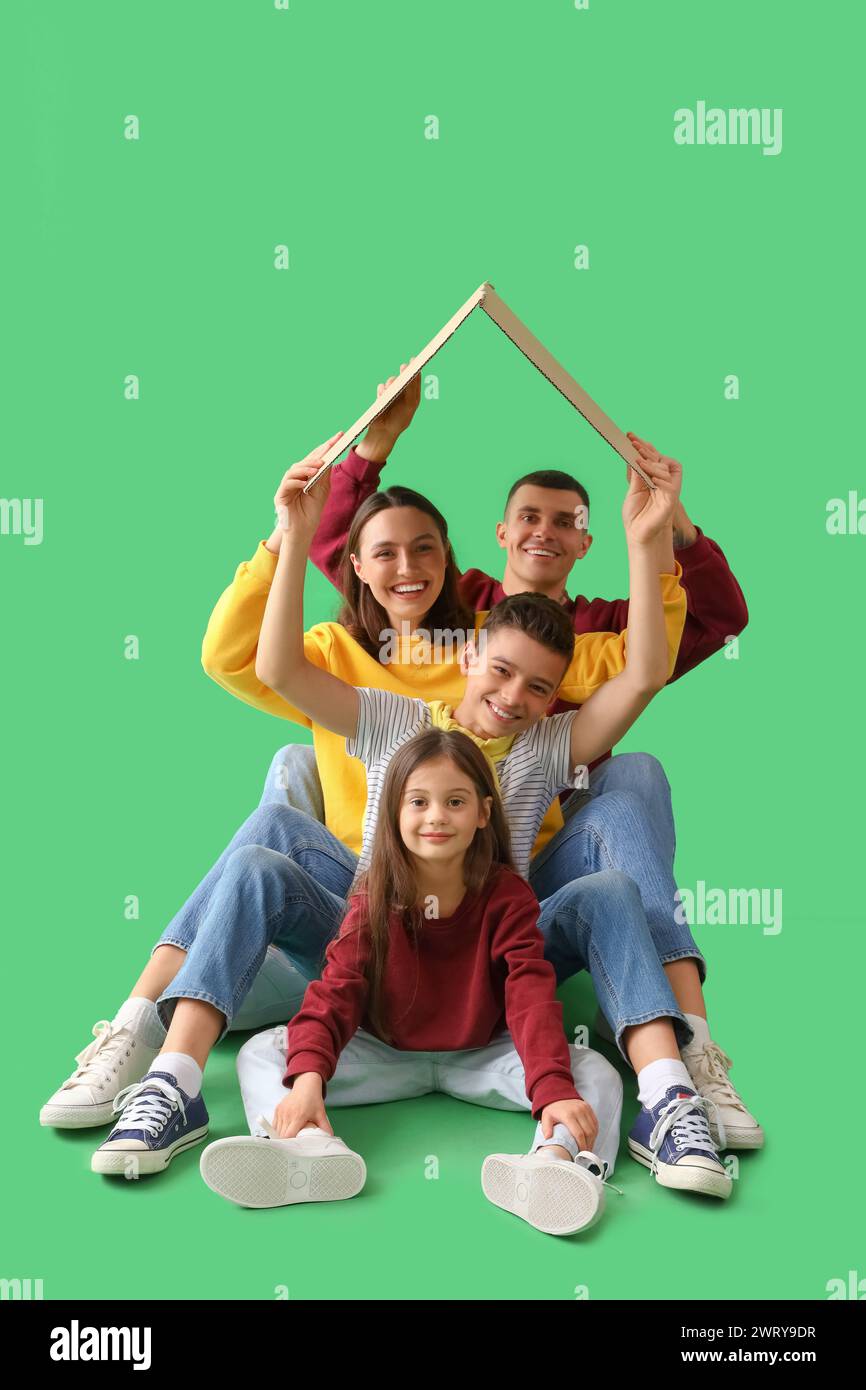Little children with their parents and cardboard paper on green ...