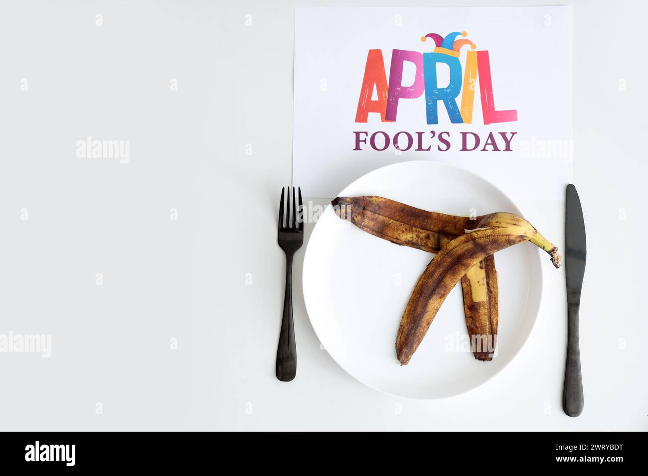 Table serving with banana peel on plate and APRIL FOOL'S DAY poster ...