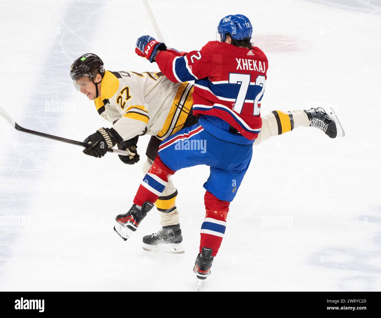 Montreal Canadiens' Arber Xhekaj (72) checks Boston Bruins' Hampus