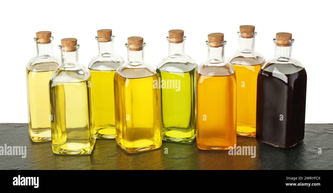 Vegetable fats. Bottles of different cooking oils on wooden table