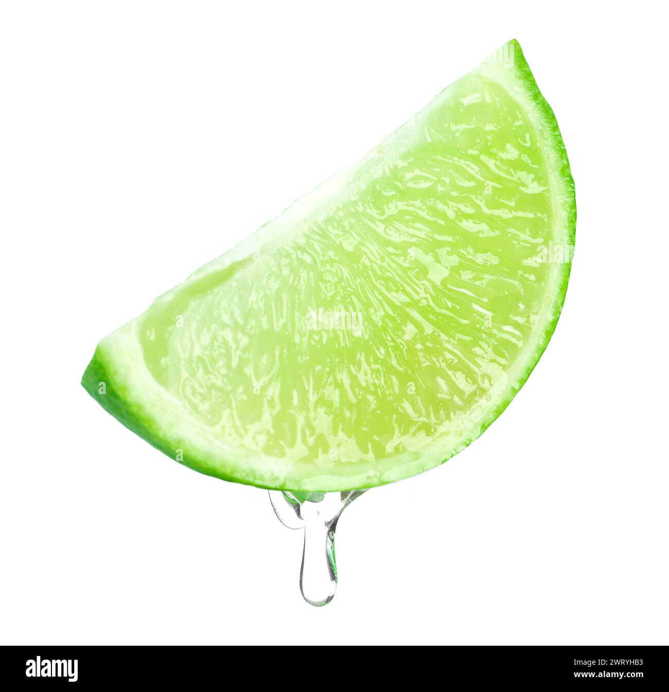 Lime juice dripping from fruit on white background Stock Photo