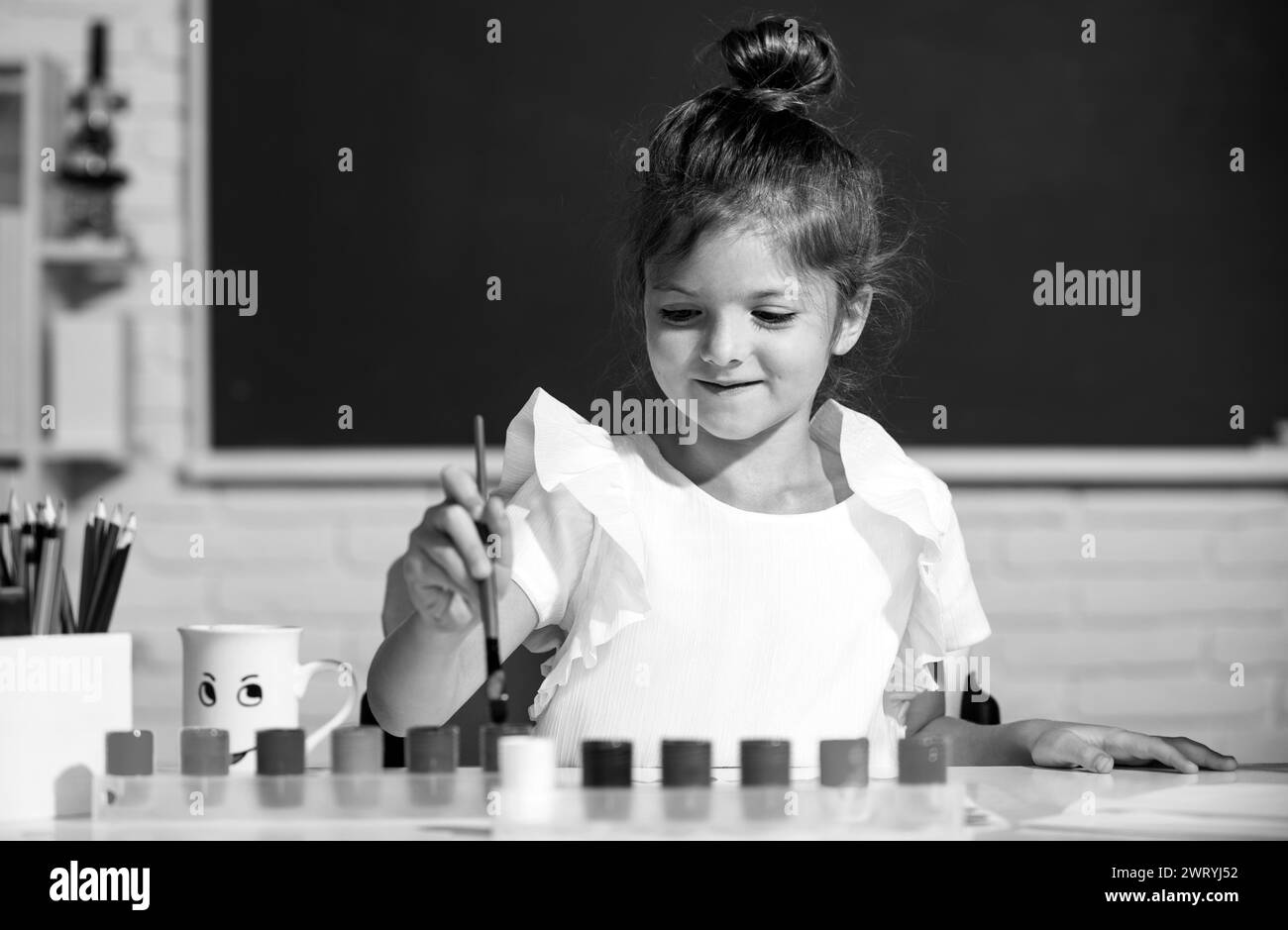 Cute little preschooler child girl drawing at school. Child girl ...