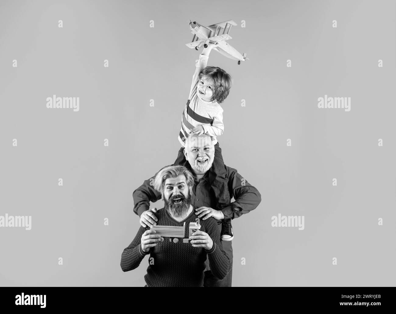 Fathers day. Kid having fun with toy plane. Men generation family with