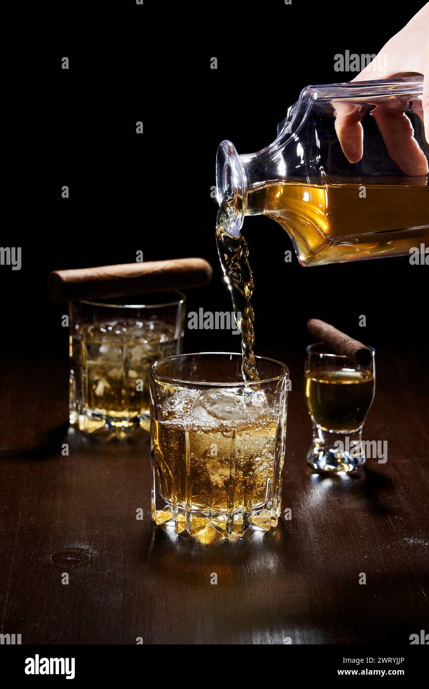 filling a glass with alcohol Stock Photo