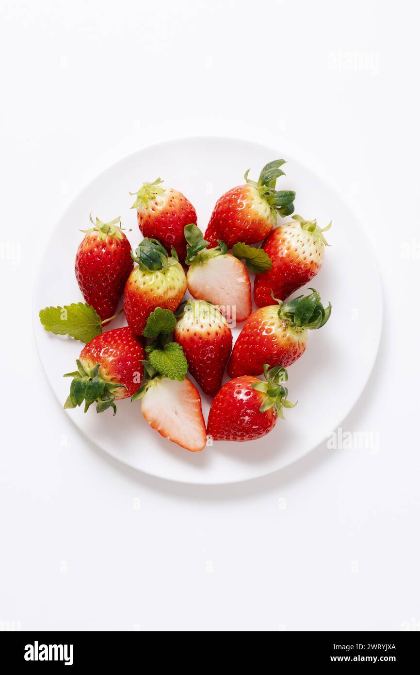 a pile of strawberries in a plate Stock Photo