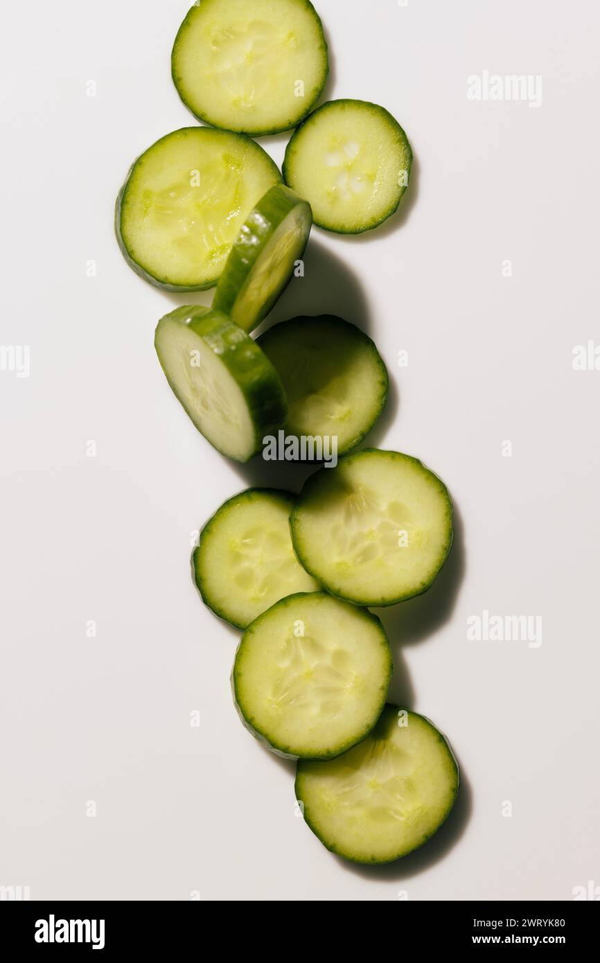 a pile of circular cucumbers on a white background Stock Photo