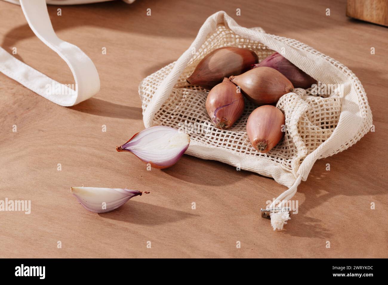 a pile of shallots in a net bag Stock Photo