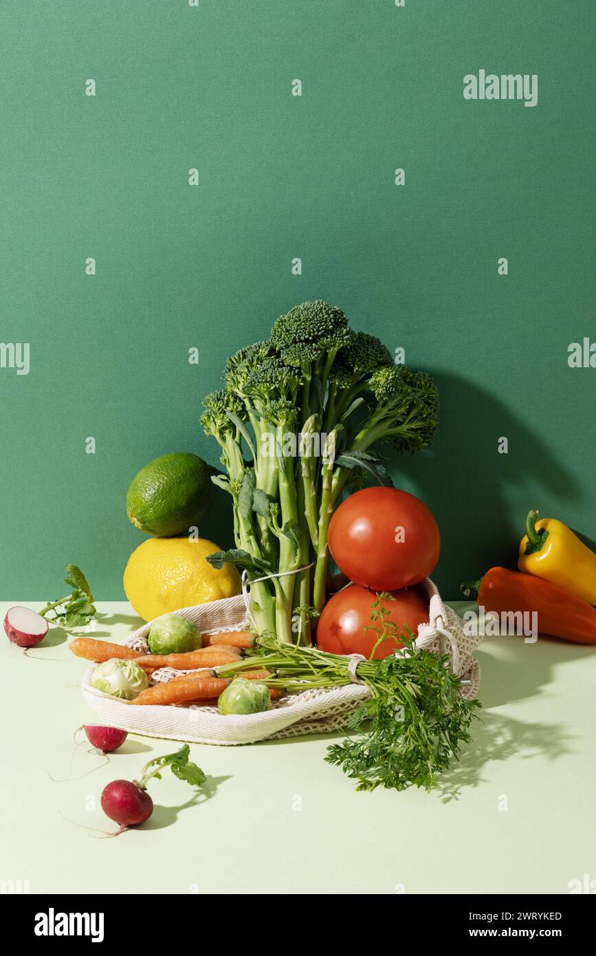 a pile of various vegetables and fruits against a green background Stock Photo