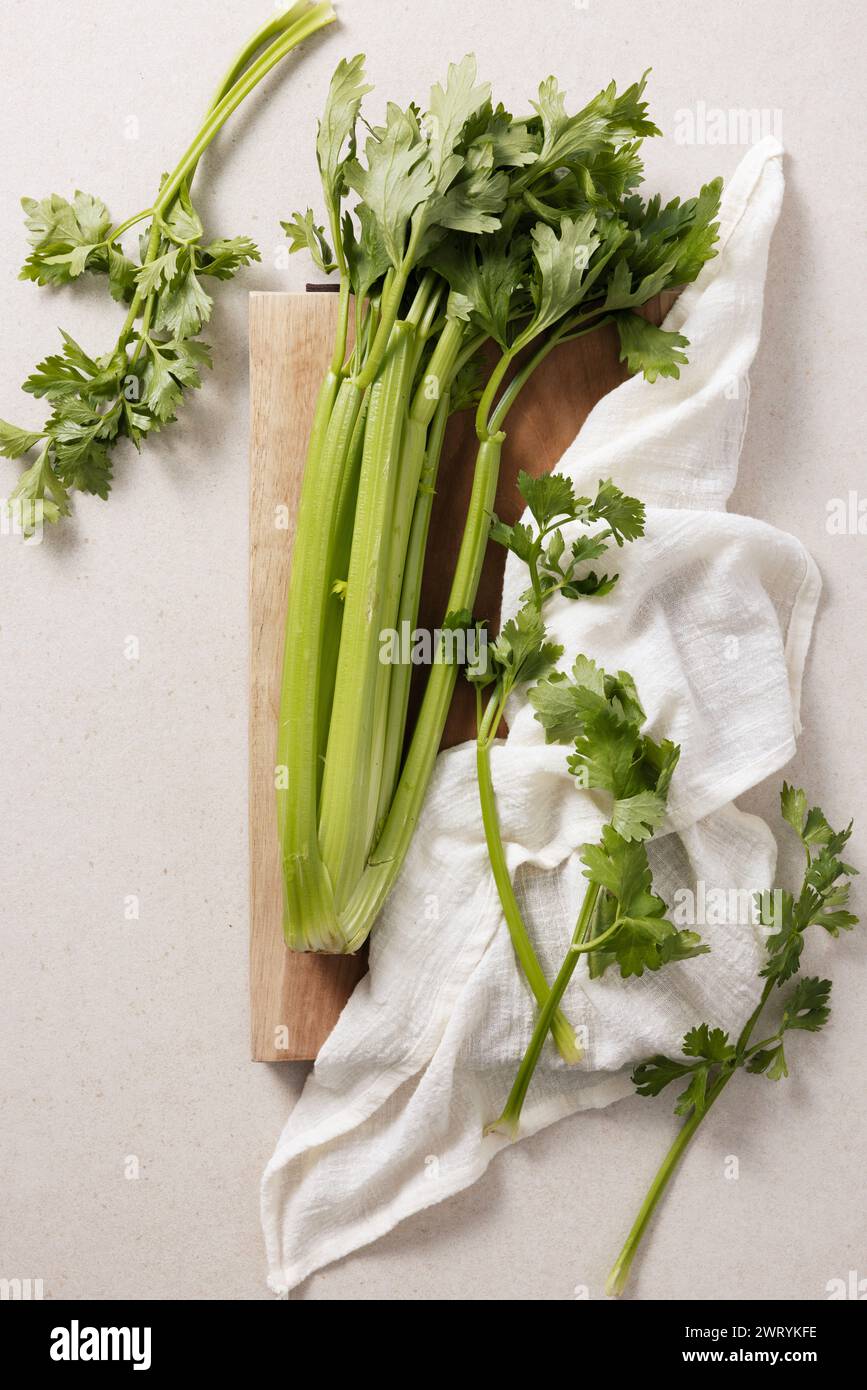 fresh celery handa feet on a wooden chopping board Stock Photo