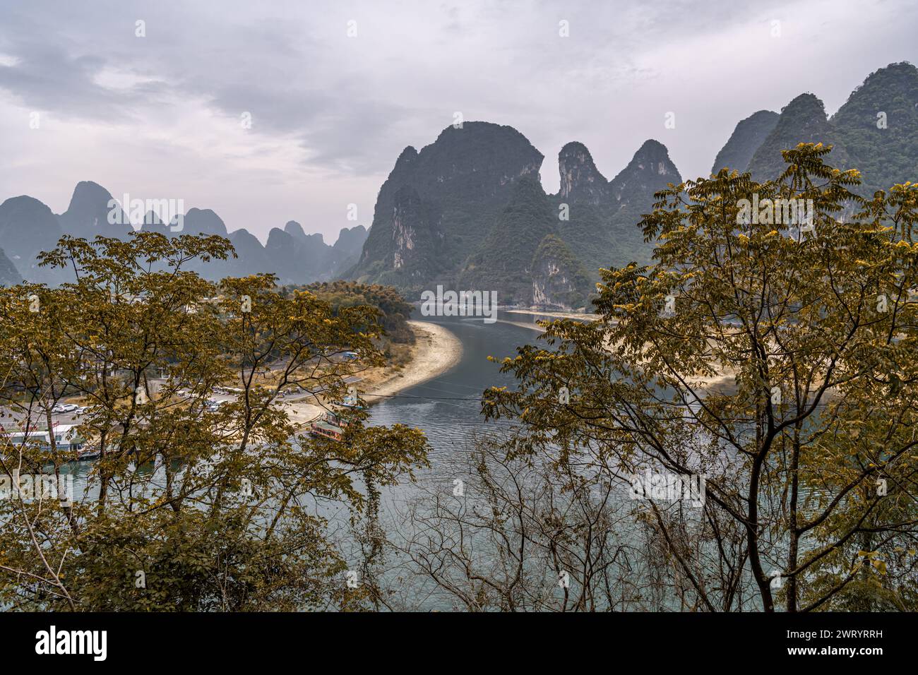 View of the Li River (Lijiang River) with azure water among scenic karst mountains at Yangshuo County of Guilin, China. Green hills on blue sky backgr Stock Photo