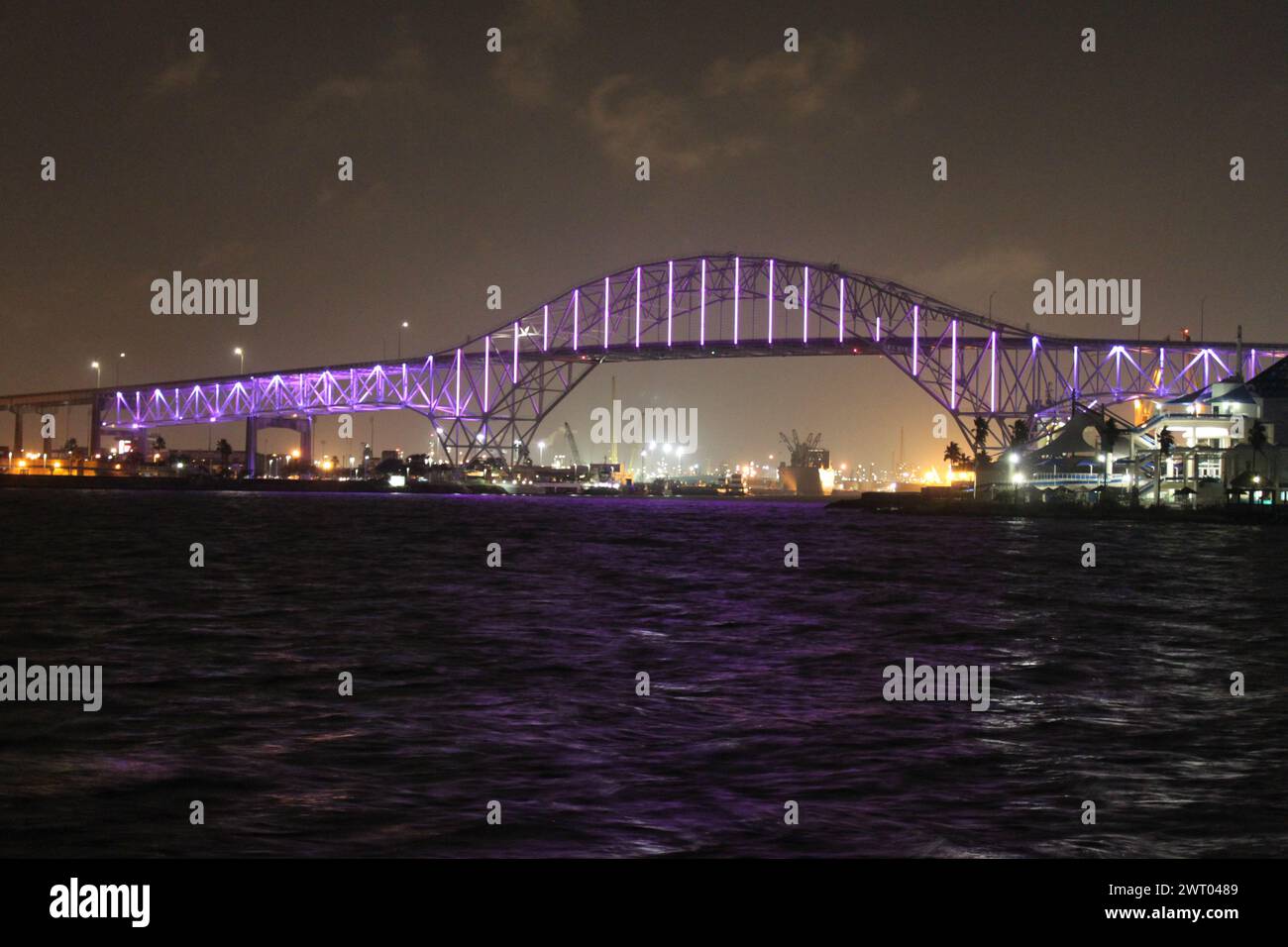 Corpus Christi, Texas, November 3, 2017: The violet illuminated old arch Harbor bridge in Corpus Christi at nighttime. Stock Photo