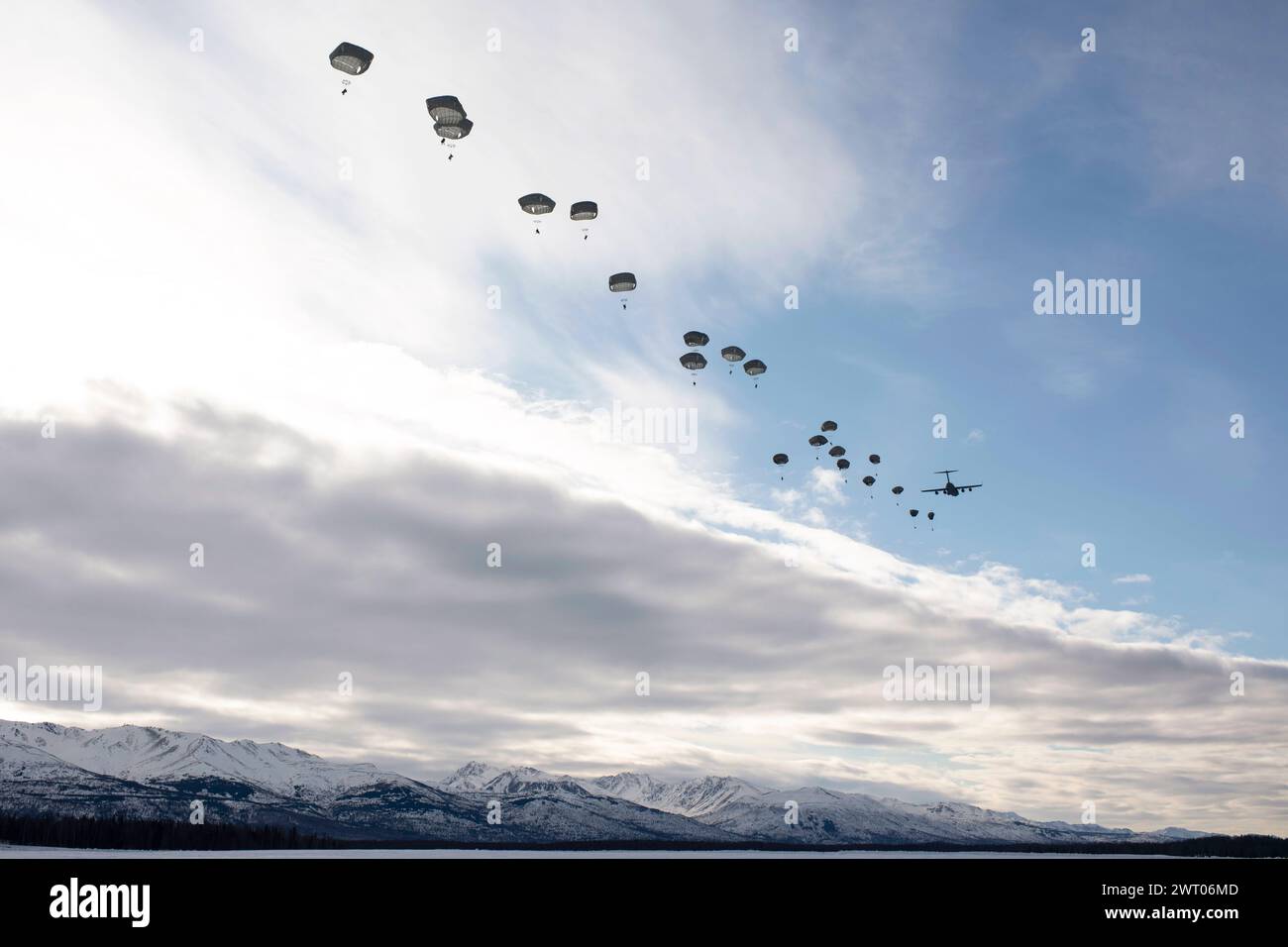 March 7, 2024 - Joint Base Elmendorf-Richardson, Alaska, USA - Female U.S. Army paratroopers with the 2nd Infantry Brigade Combat Team, 11th Airborne Division 'Arctic Angels'' jump from a C-17 Globemaster III assigned to the 176th Wing, Alaska Air National Guard, in honor of International Womens Day, at Malemute Drop Zone, Joint Base Elmendorf-Richardson, Alaska, March 7, 2024. The jump was conducted by female members of the 2/11, and included jumpers and jump masters from all 2/11th battalions with all ground and air duties executed by female Soldiers and Airmen. (photo by Julia Lebens) (C Stock Photo