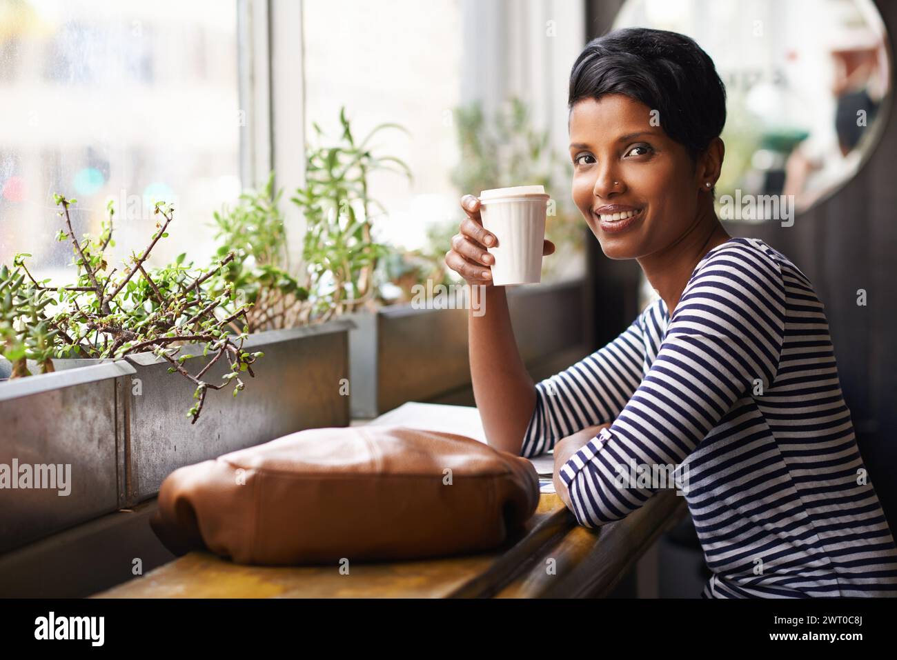 Coffee, smile and portrait of woman in cafe for morning with positive, good and confident attitude. Happy, face and female person from Mexico drinking Stock Photo